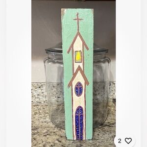 Folk art painting of church on wood